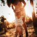 woman in white tank top and white shorts standing on forest during daytime